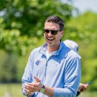 The winning team smiles and claps after the game